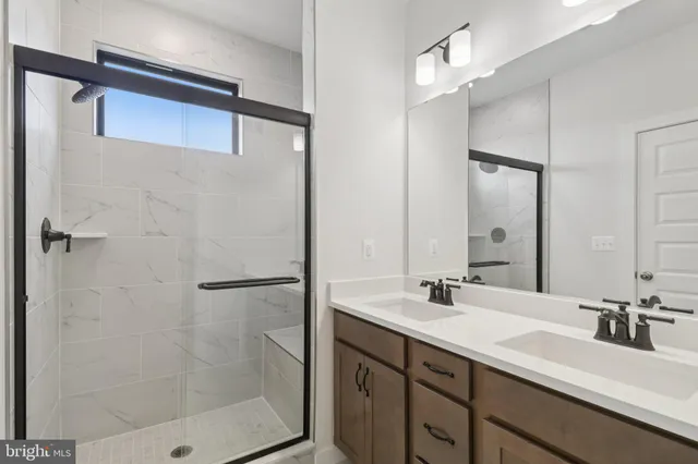 a bathroom with a sink double vanity and a mirror
