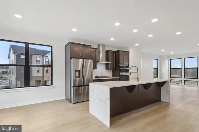 a kitchen with stainless steel appliances a refrigerator and a sink