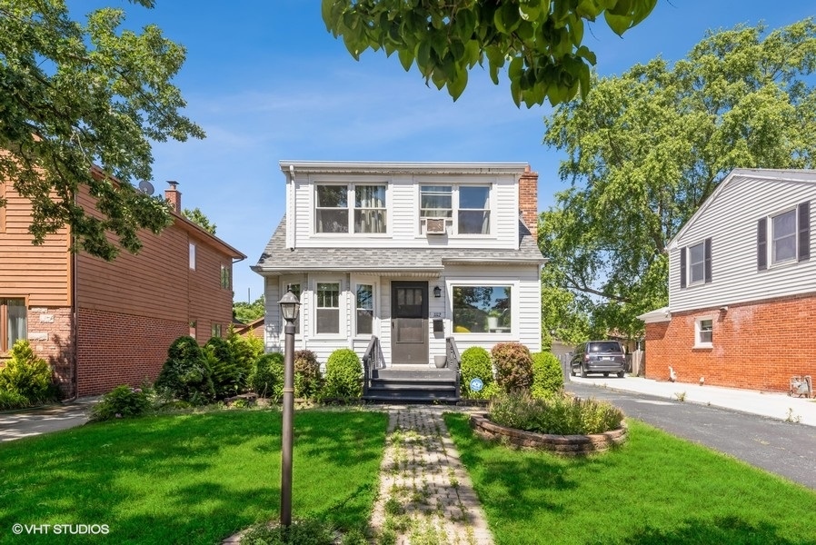 a front view of a house with a yard and porch