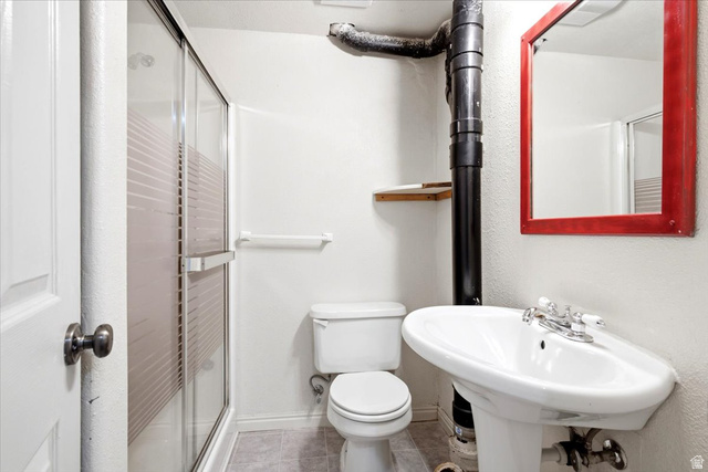 1341 29th Street Ogden, UT 84403 - Photo 23 of 37 Bathroom featuring a pedestal sink with chrome fixtures, a toilet, and a stand-up shower with a clear glass enclosure