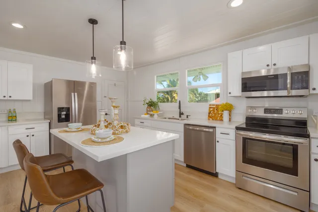 a kitchen with a sink stove and white cabinets