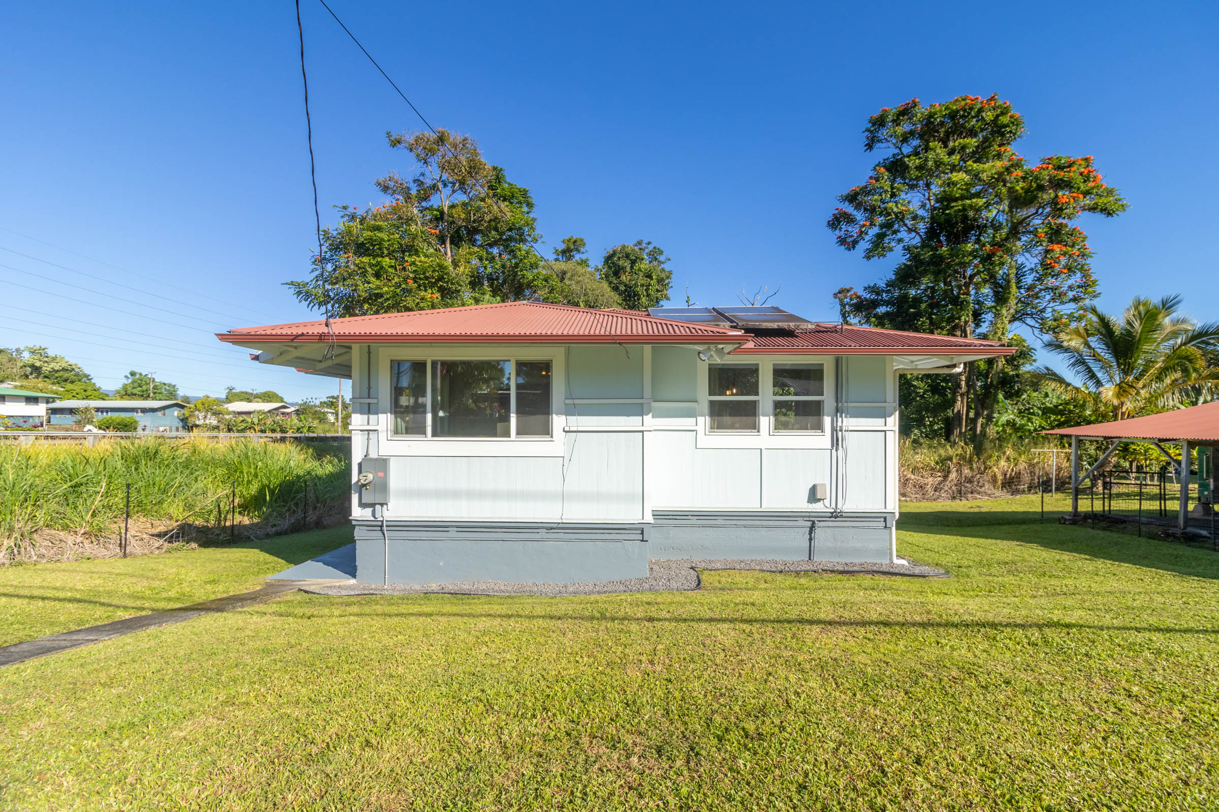 75 East Palai Street Hilo, HI 96720 - Photo 29 of 29 a front view of a house with a yard table and chairs