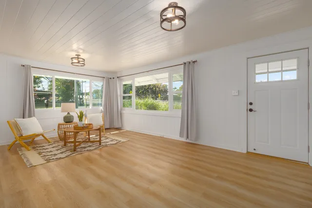 a living room with furniture and a floor to ceiling window