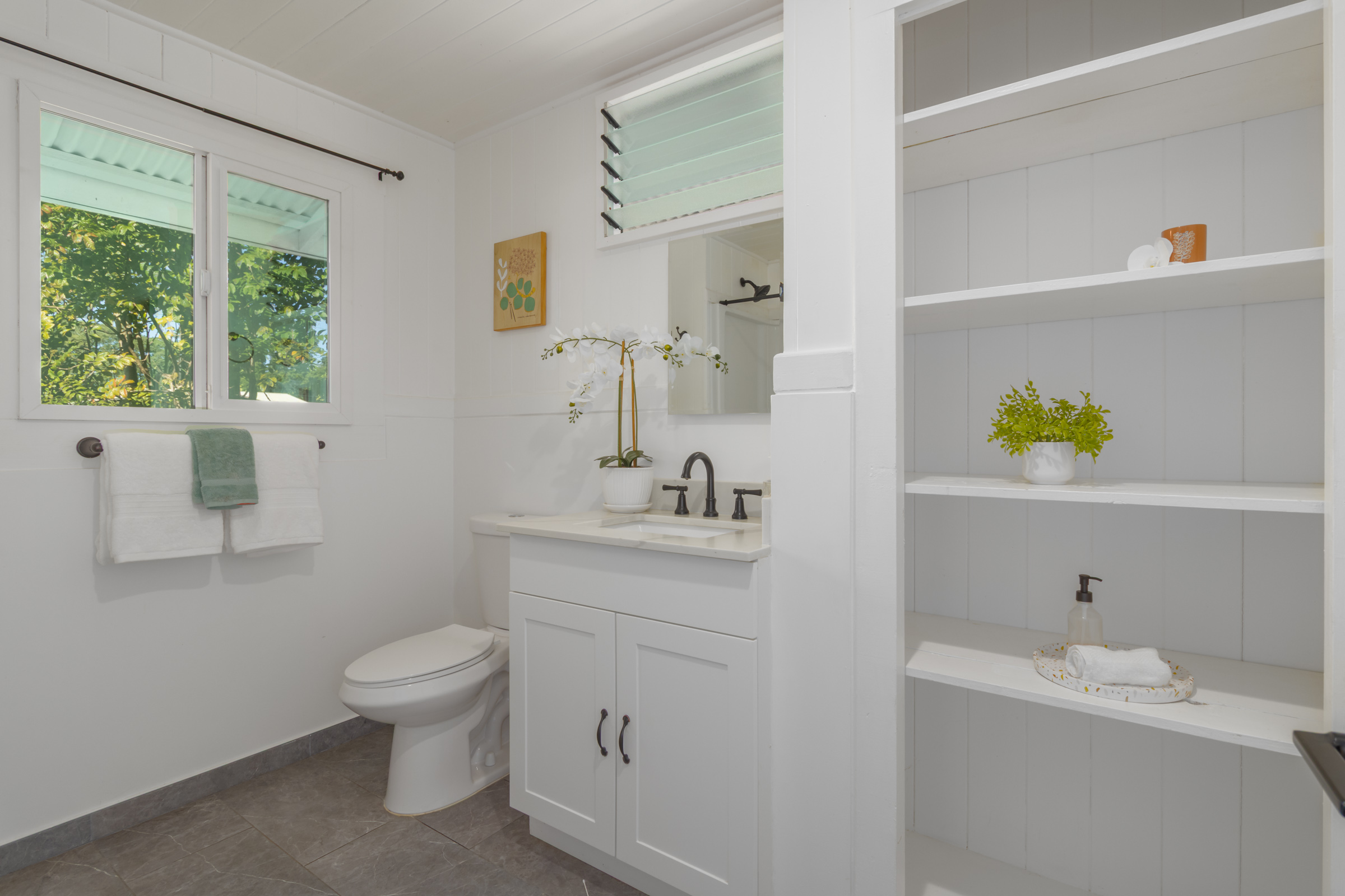 75 East Palai Street Hilo, HI 96720 - Photo 8 of 29 a spacious bathroom with a sink a toilet and a mirror