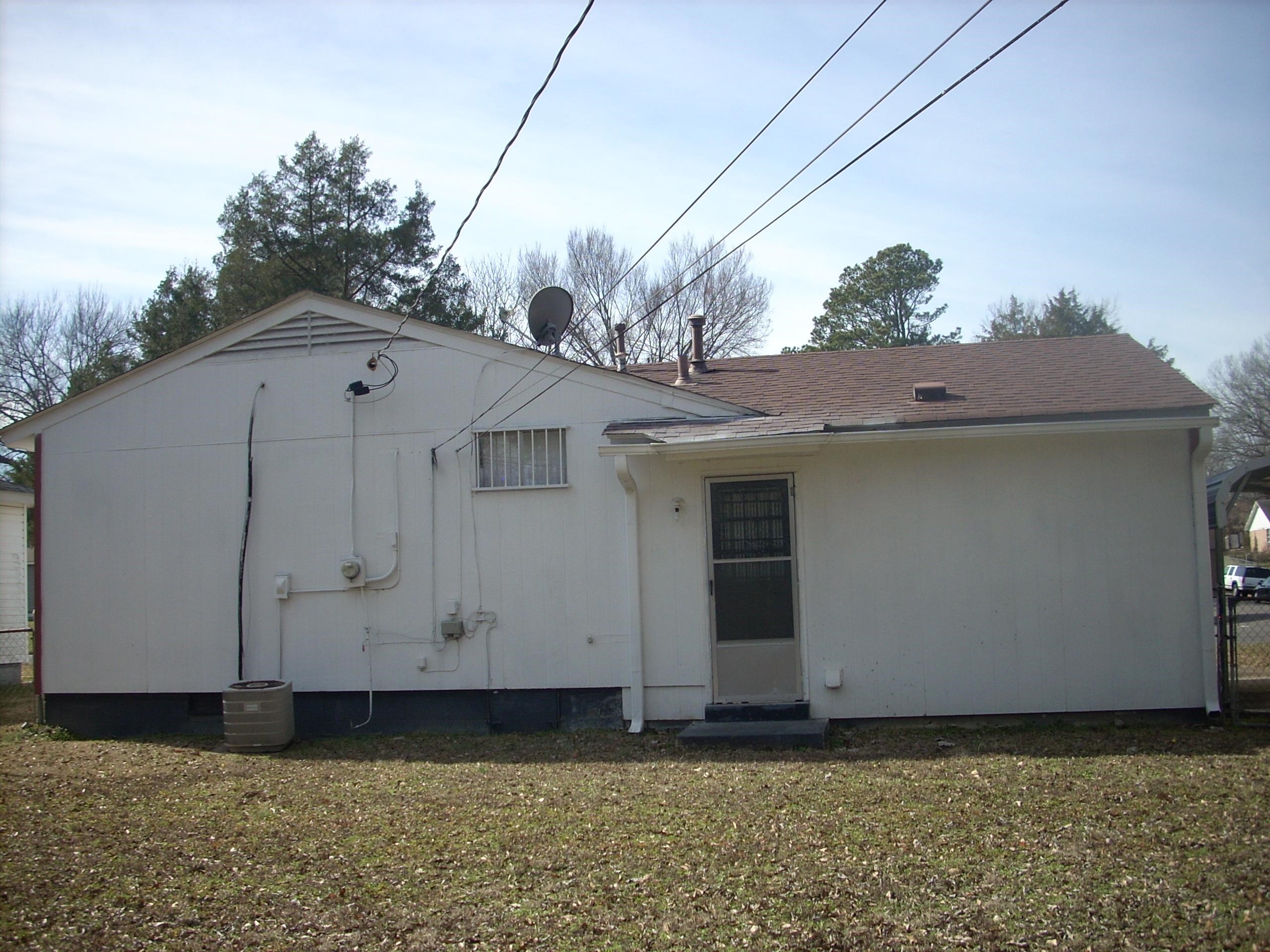 4282 Westmont Road Memphis, TN 38109 - Photo 2 of 15 Back of house featuring a lawn, crawl space, and roof with shingles