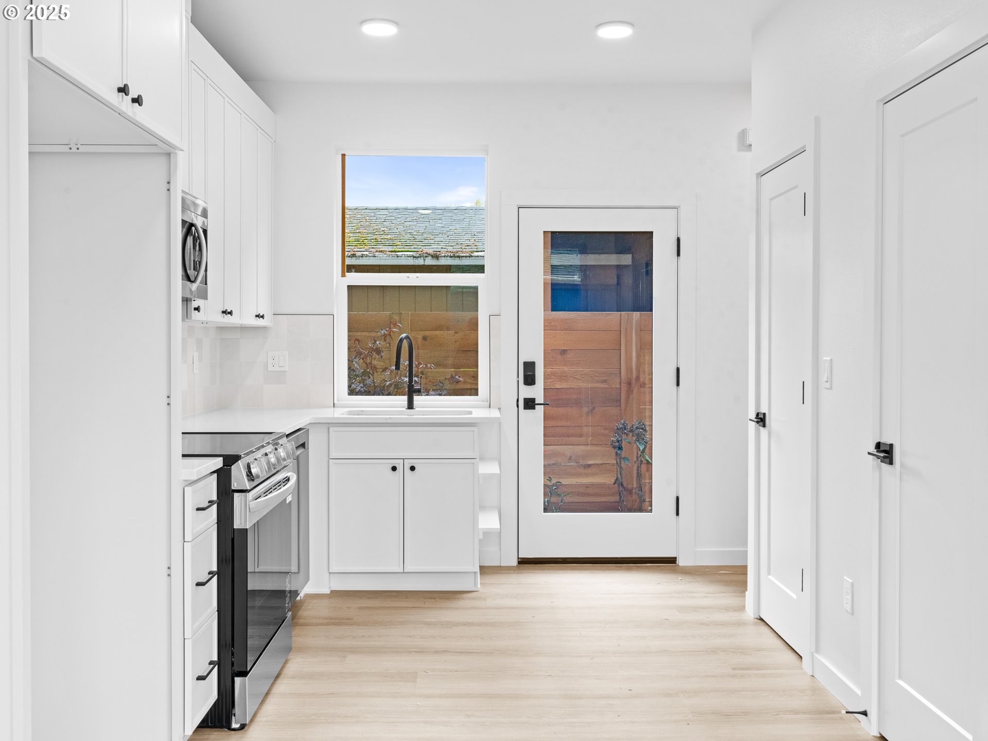 8420 Southeast Clay Street Portland, OR 97216 - Photo 2 of 16 a view of a kitchen with a sink and a window
