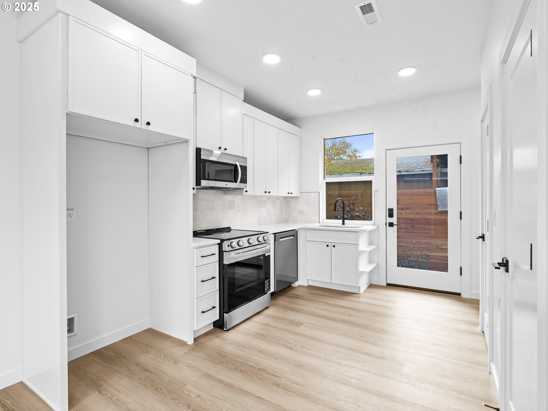 8420 Southeast Clay Street Portland, OR 97216 - Photo 3 of 16 a kitchen with granite countertop a stove a sink and a refrigerator