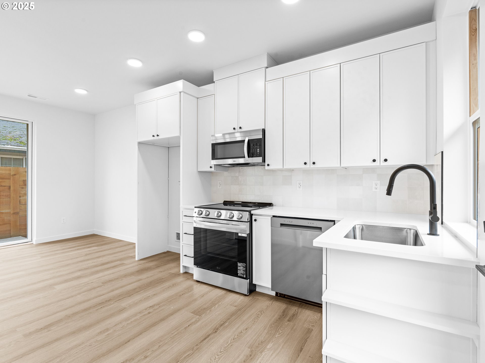 8420 Southeast Clay Street Portland, OR 97216 - Photo 4 of 16 a kitchen with stainless steel appliances granite countertop a stove and a sink