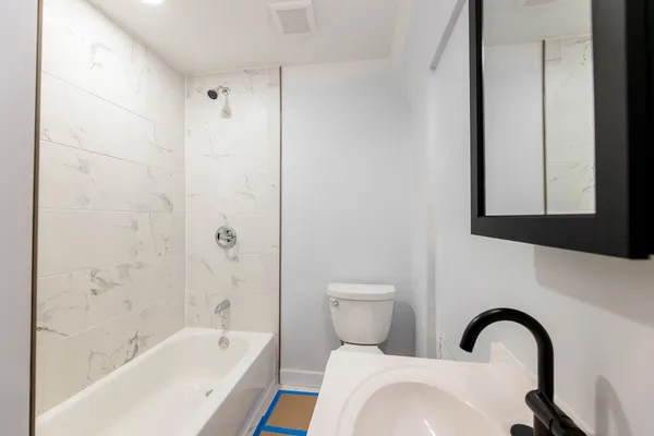 a bathroom with a bathtub and shower