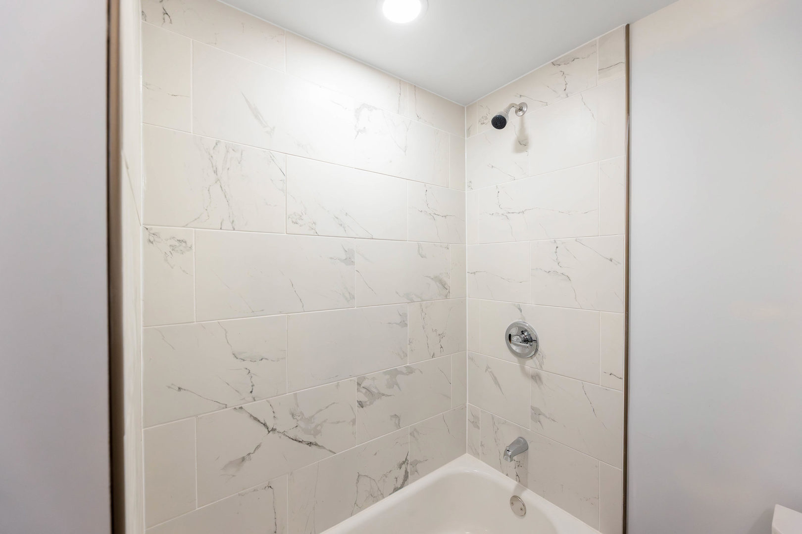 2834 West 36th Street Chicago, IL 60632 - Photo 16 of 24 a bathroom with a bathtub and shower