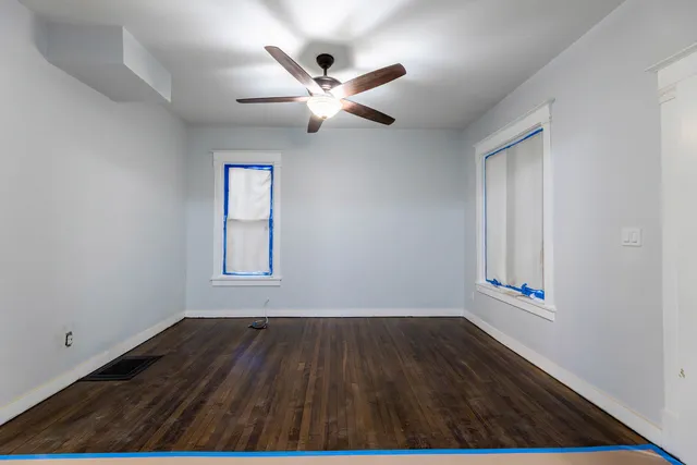 wooden floor in an empty room with a window