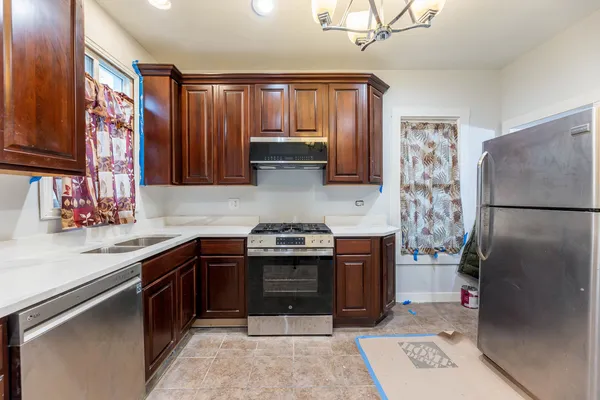 a kitchen with stainless steel appliances granite countertop a sink stove and refrigerator