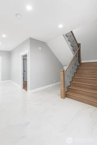 a view of entryway and hall with wooden floor