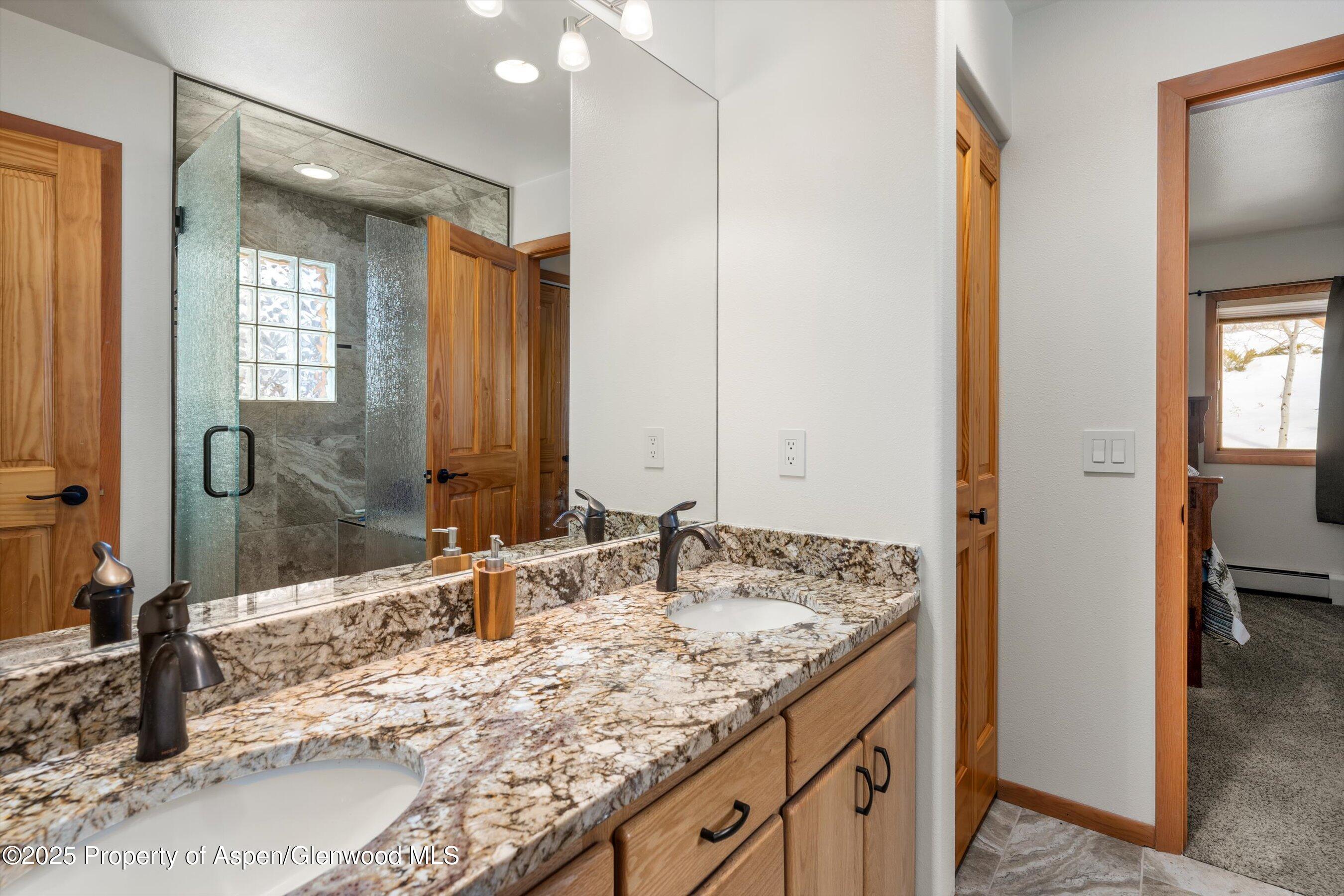 238 Hawk Lane Basalt, CO 81621 - Photo 23 of 46 a bathroom with a granite countertop sink and a mirror
