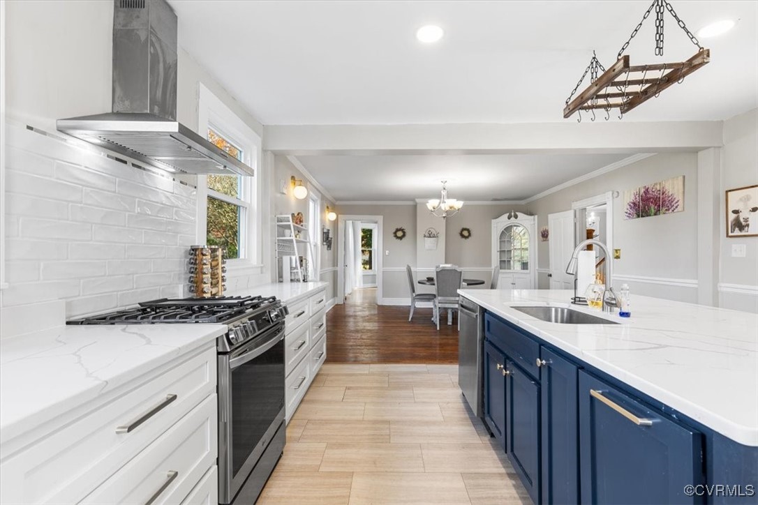 Kitchen featuring wall chimney exhaust hood, blue
