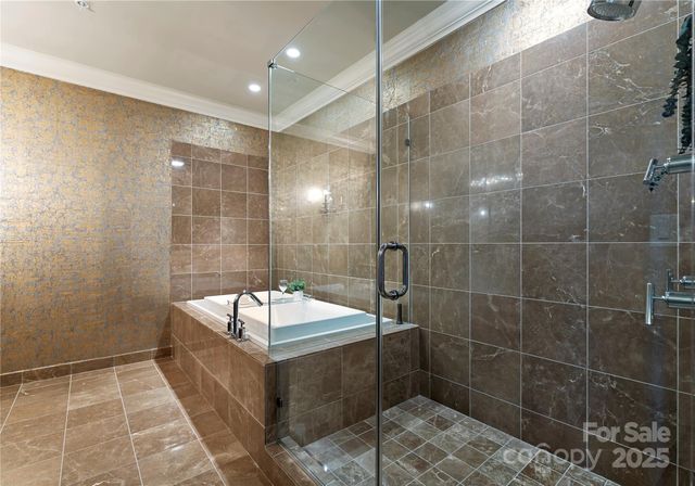 a bathroom with a tub a toilet a sink and shower