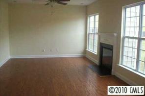 1318 Secret Path Drive, Unit 242 Fort Mill, SC 29708 - Photo 3 of 5 an empty room with wooden floor and windows