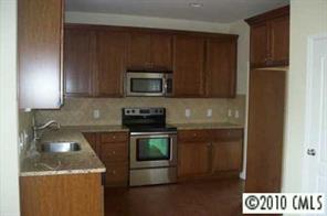 1318 Secret Path Drive, Unit 242 Fort Mill, SC 29708 - Photo 4 of 5 a kitchen with a stove microwave and sink