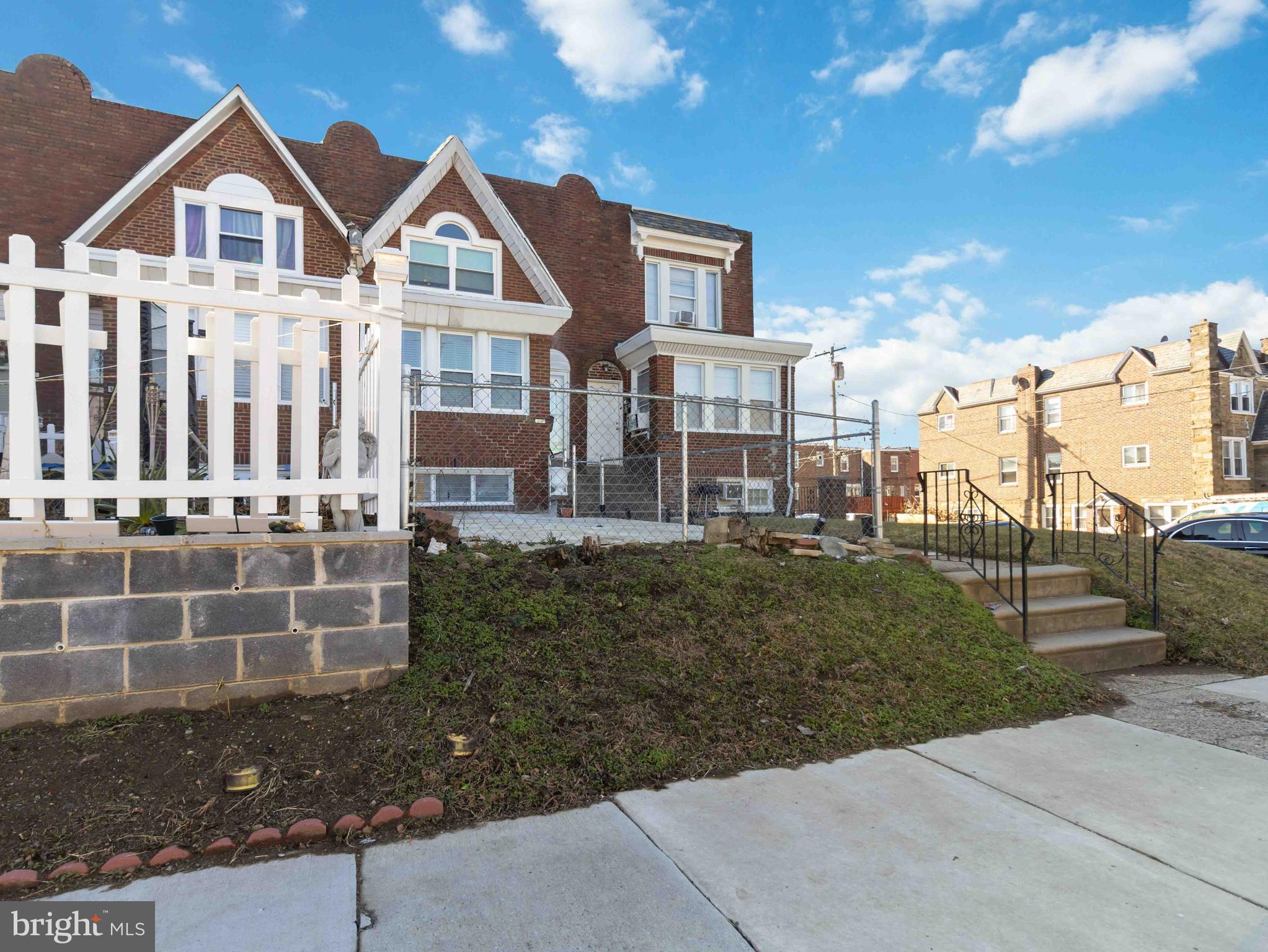 a front view of a residential apartment building with a yard