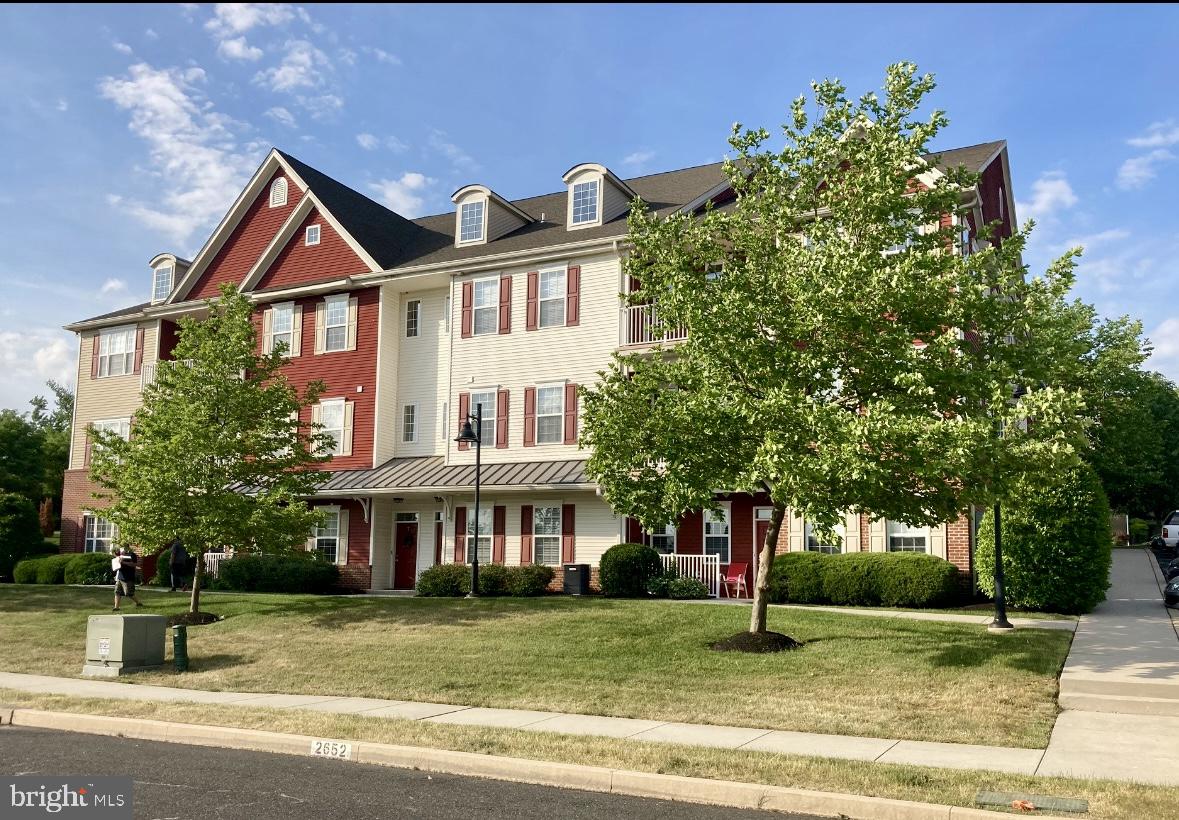 265 Covenant Lane, Unit 8 Harleysville, PA 19438 - Photo 1 of 21 a front view of a house with a yard