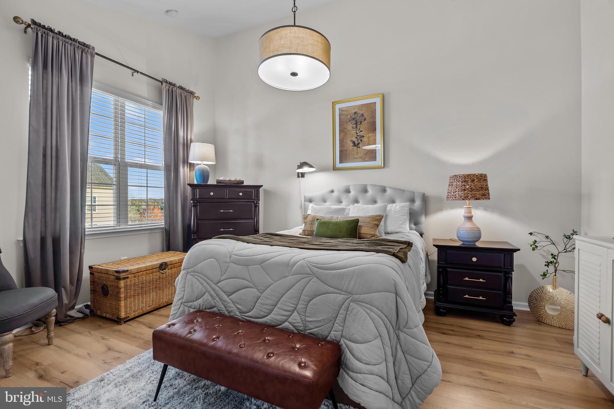 265 Covenant Lane, Unit 8 Harleysville, PA 19438 - Photo 12 of 21 a bedroom with a bed and wooden floor