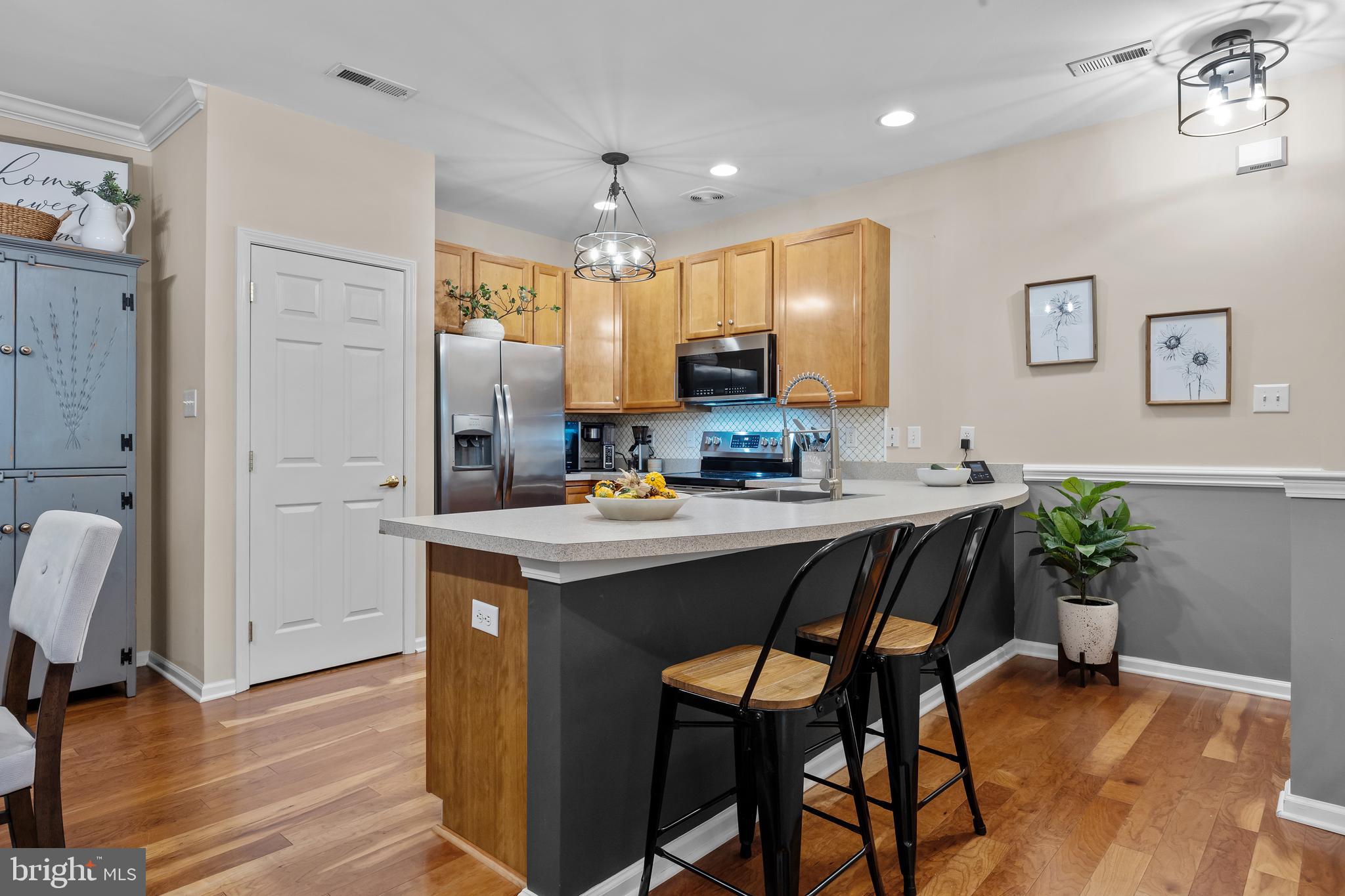 265 Covenant Lane, Unit 8 Harleysville, PA 19438 - Photo 5 of 21 a kitchen with kitchen island a table and chairs in it