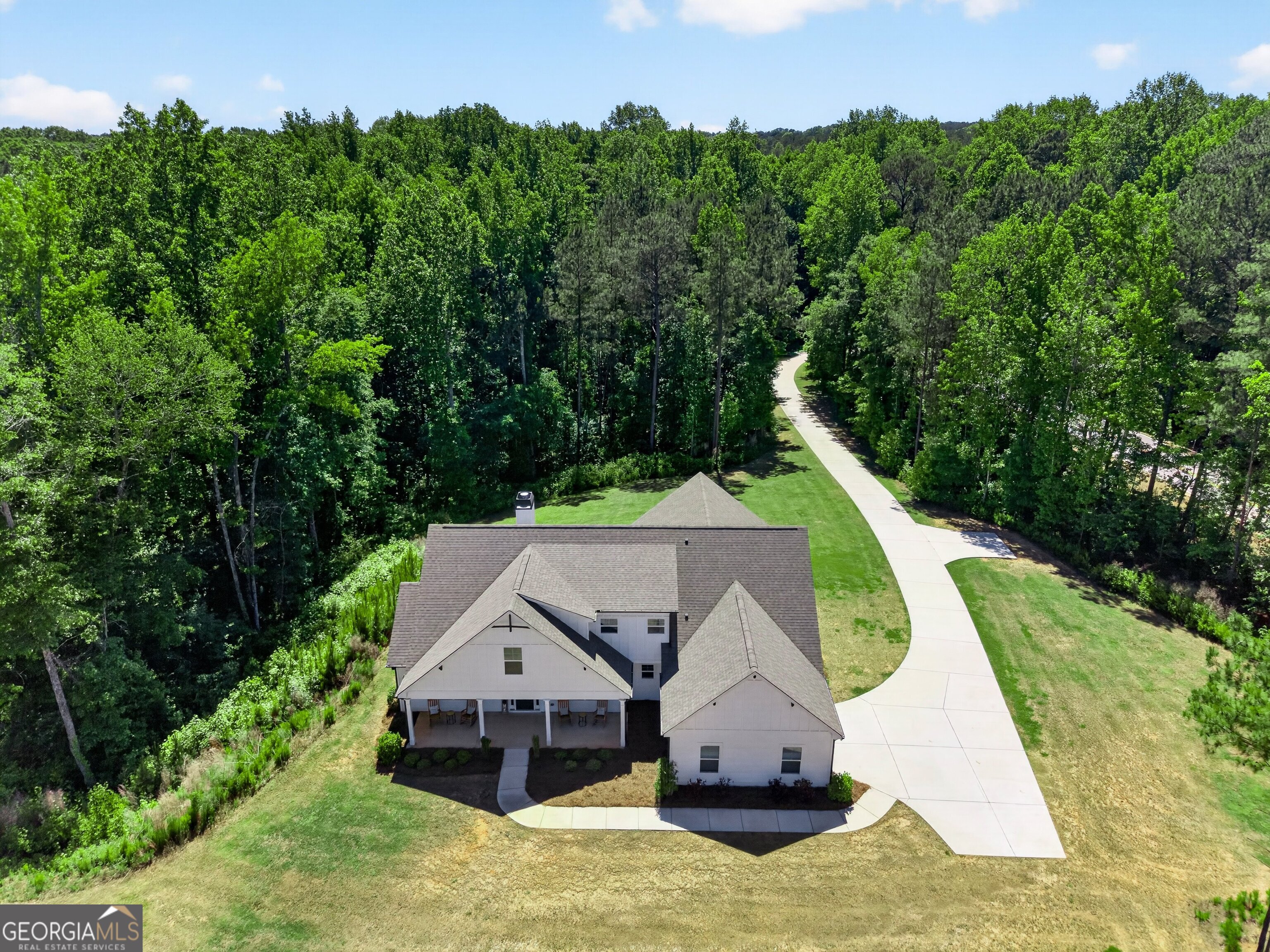 1764 Luther Bailey Road Senoia, GA 30276 - Photo 52 of 63 a view of a house with a small yard and large trees