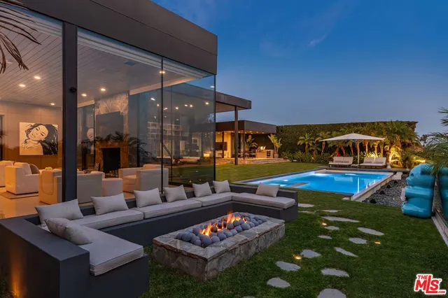 a living room with furniture a rug and a fireplace