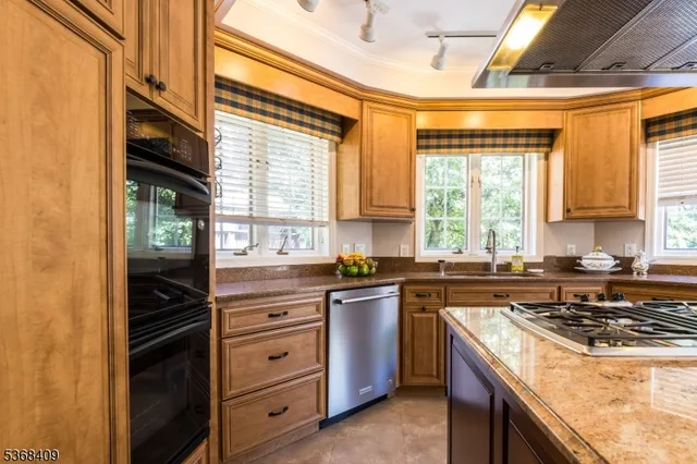 a kitchen with a stove a sink and a refrigerator