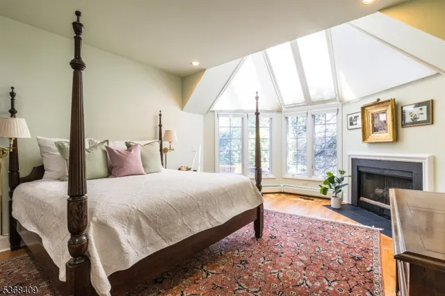 a spacious bedroom with a bed and a fireplace