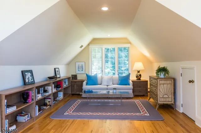 a living room with furniture and a book shelf