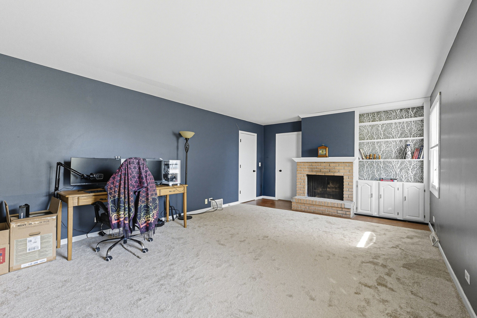 21182 Virginia Road DeKalb, IL 60115 - Photo 13 of 44 a view of a livingroom with a fireplace and workspace