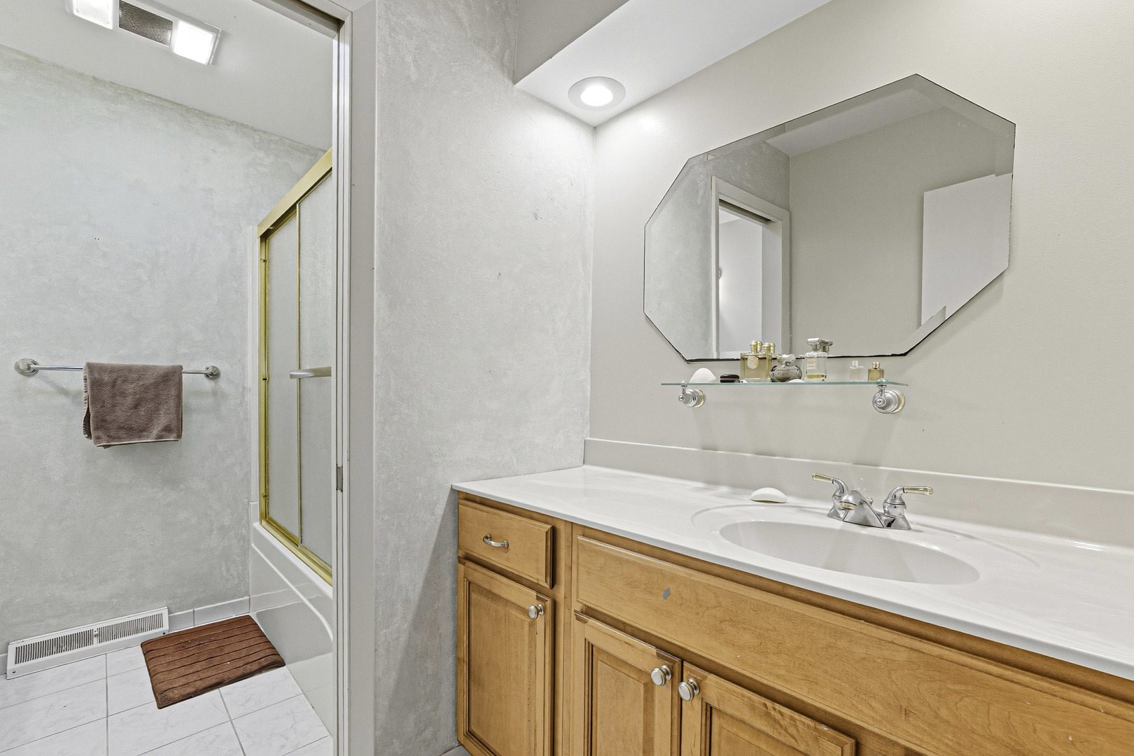 21182 Virginia Road DeKalb, IL 60115 - Photo 18 of 44 a bathroom with a sink vanity and mirror