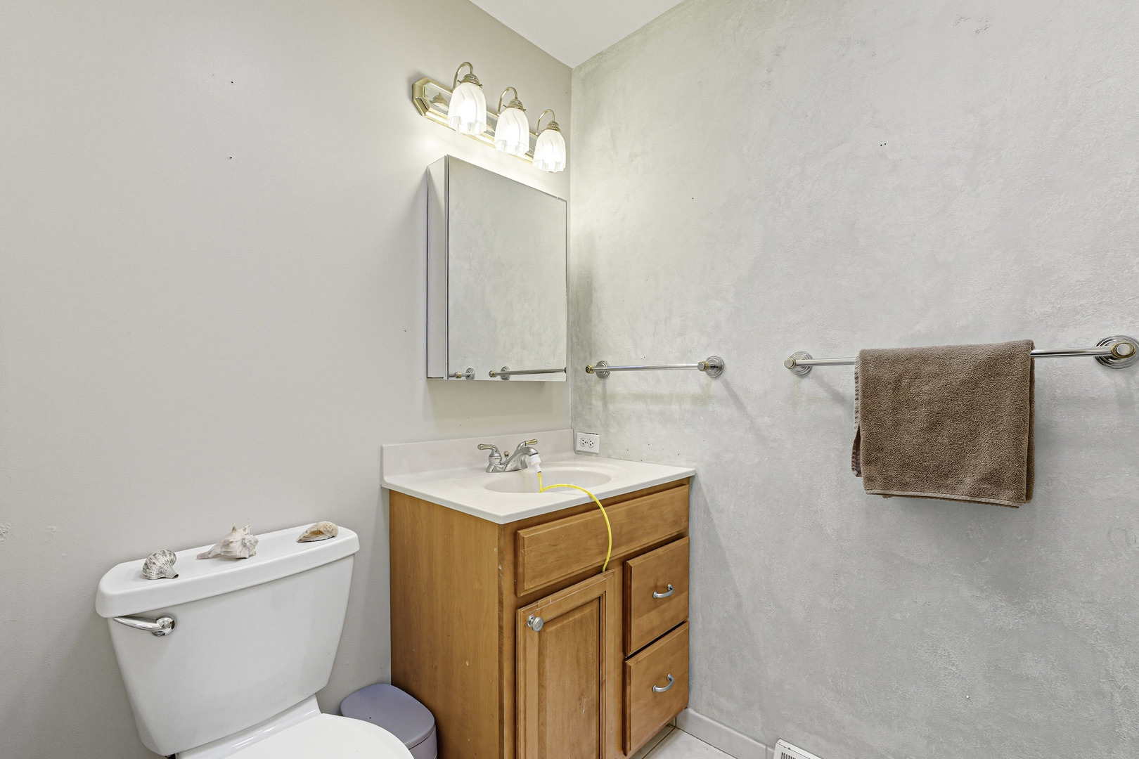 21182 Virginia Road DeKalb, IL 60115 - Photo 19 of 44 a bathroom with a toilet sink and mirror