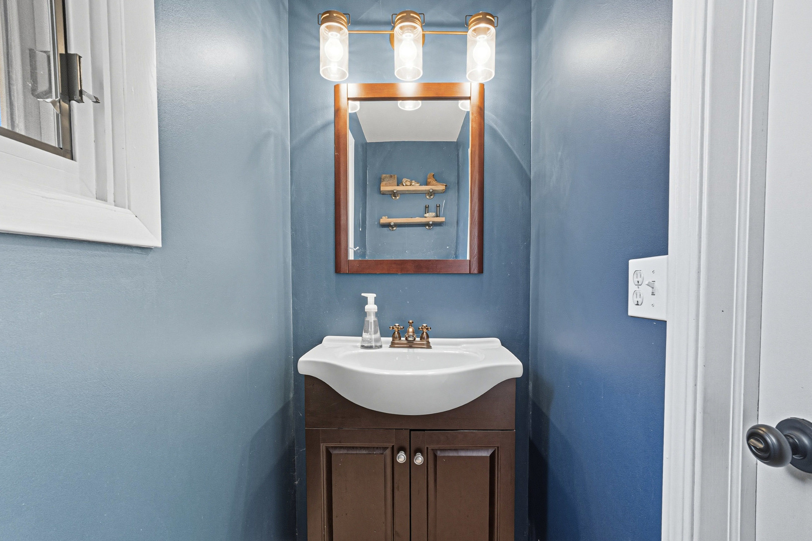21182 Virginia Road DeKalb, IL 60115 - Photo 28 of 44 a bathroom with a sink and a mirror