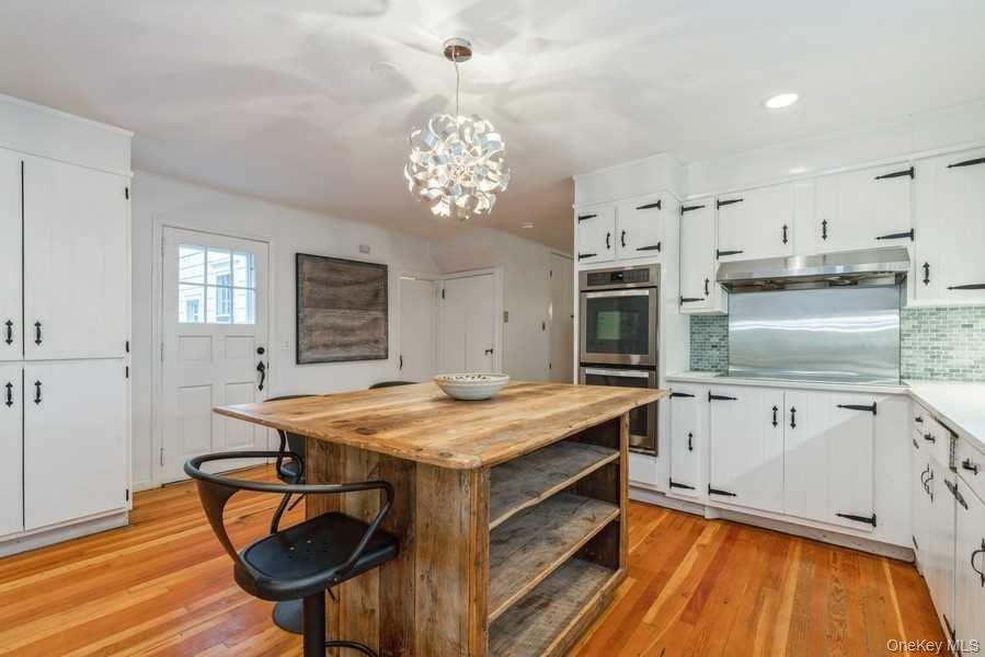1141 Beekman Road Hopewell Junction, NY 12533 - Photo 5 of 36 a kitchen with stainless steel appliances granite countertop a stove oven and a refrigerator