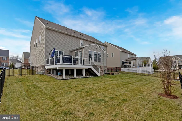 a view of a house with pool and chairs