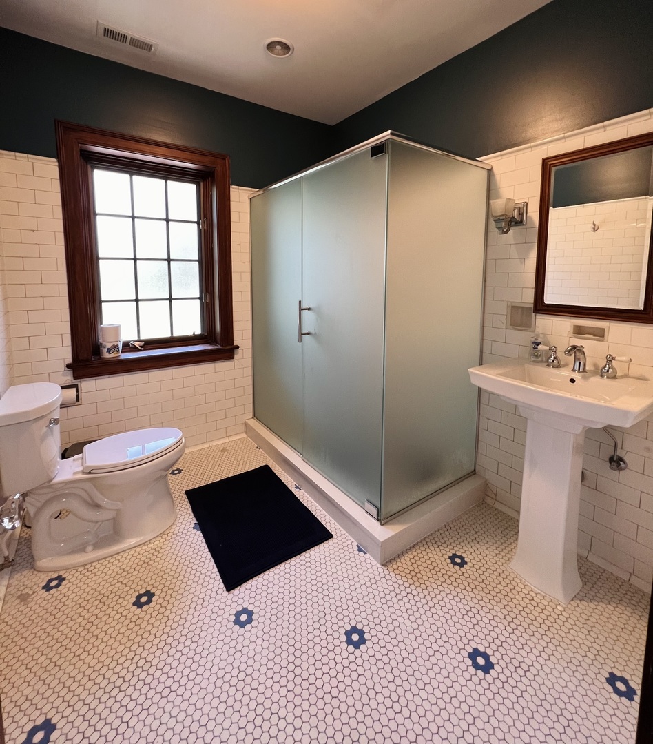 6849 Riverside Drive Berwyn, IL 60402 - Photo 20 of 33 a bathroom with a sink toilet a mirror and shower