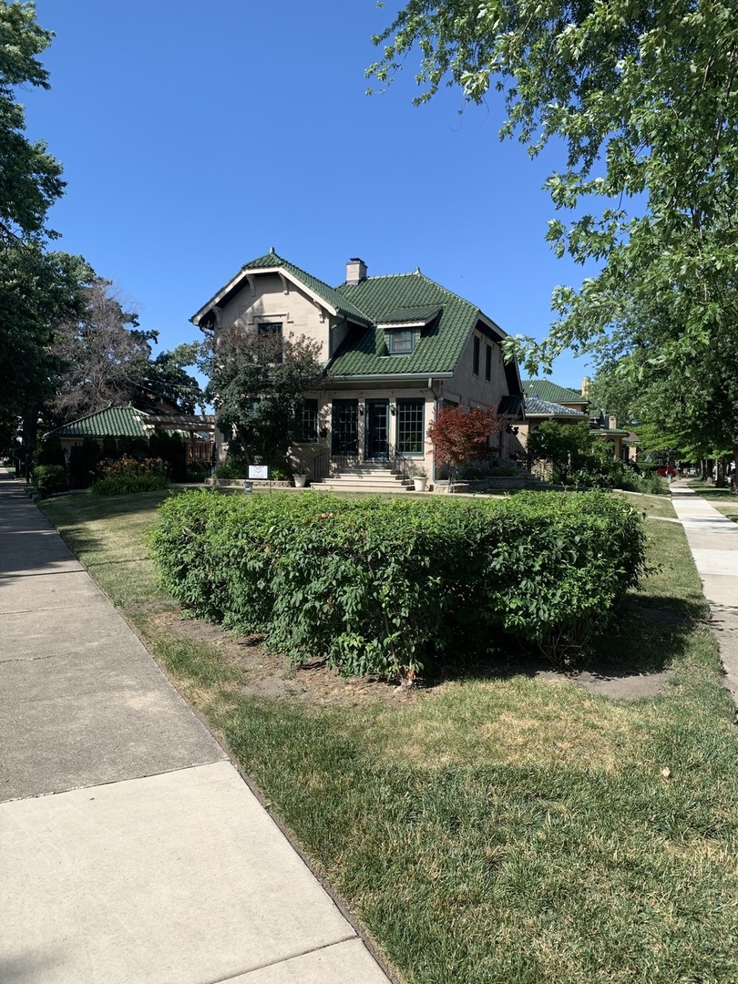 6849 Riverside Drive Berwyn, IL 60402 - Photo 2 of 33 a front view of a house with a garden
