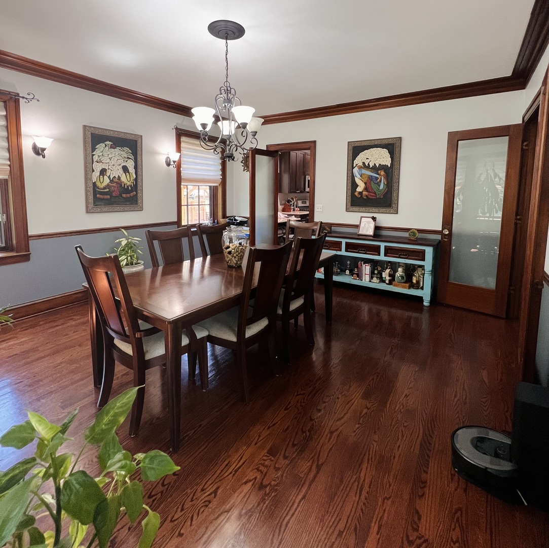 6849 Riverside Drive Berwyn, IL 60402 - Photo 9 of 33 a dining room with furniture a chandelier and wooden floor