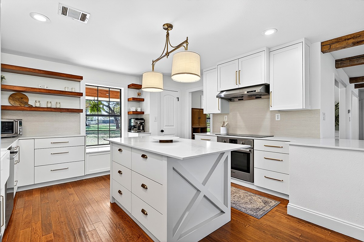 301 Medlin Creek Loop Dripping Springs, TX 78620 - Photo 9 of 40 Kitchen with white cabinetry, open shelves, stainless steel appliances, dark wood-style flooring, and beam ceiling