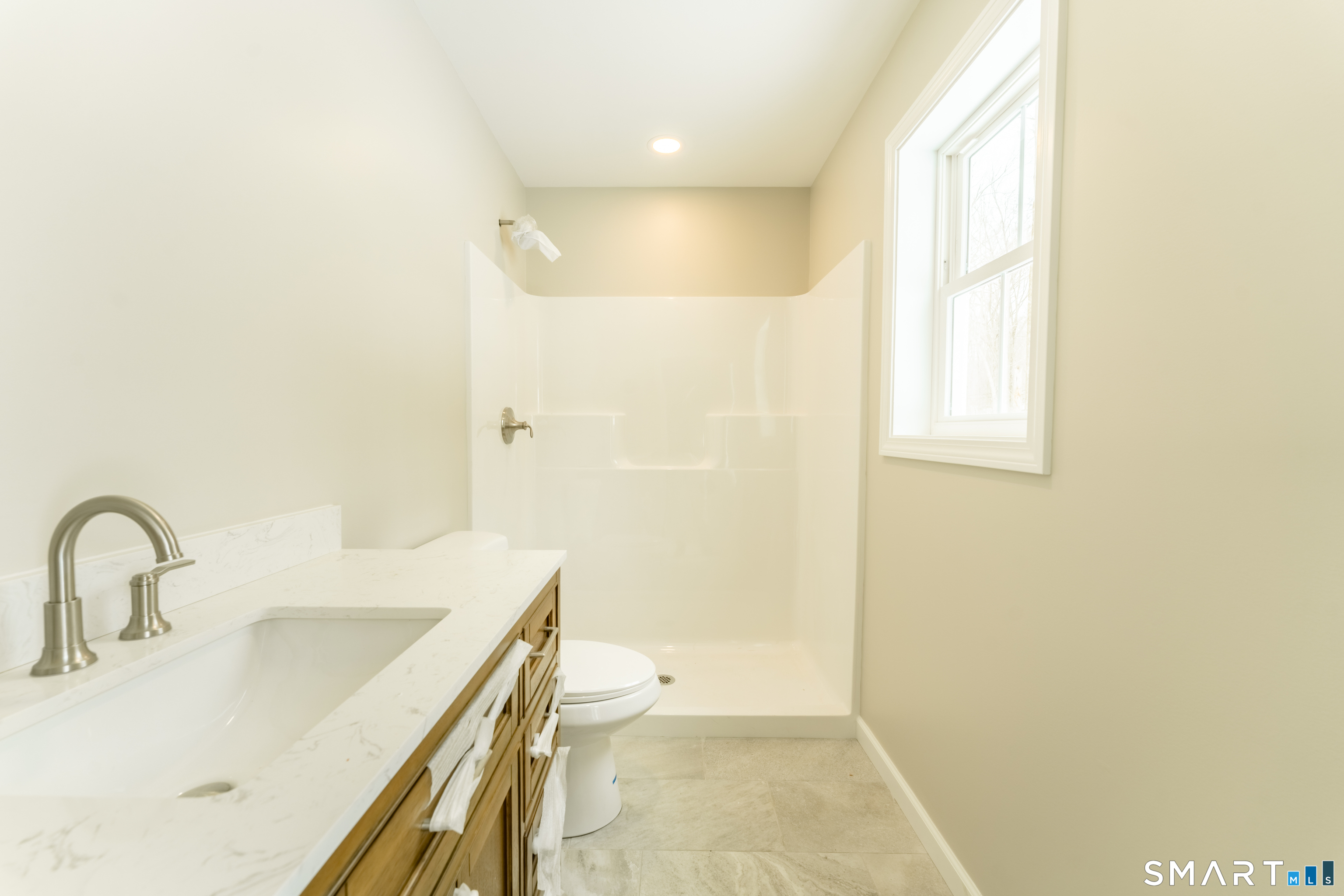 7 Halls Mill Road Preston, CT 06365 - Photo 14 of 26 a bathroom with a sink a toilet and shower