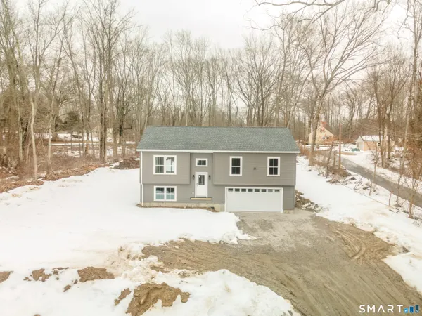 a view of a house with snow on the road