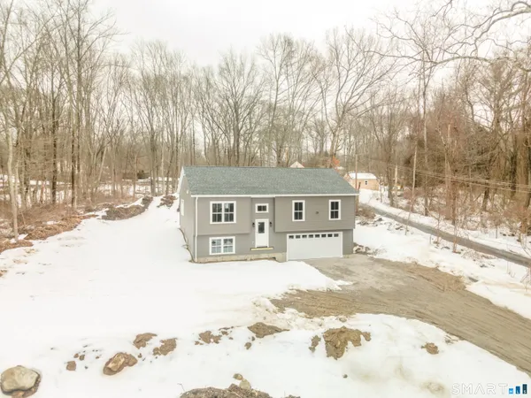 a view of a house with snow on the road
