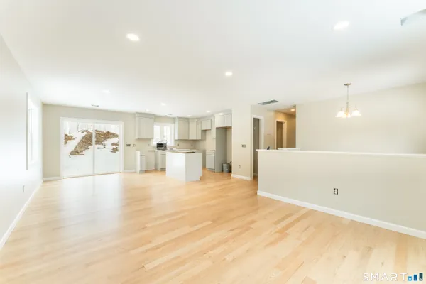 a view of a kitchen with furniture and white walls