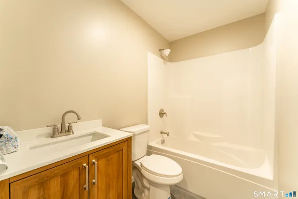 a bathroom with a sink mirror vanity and toilet