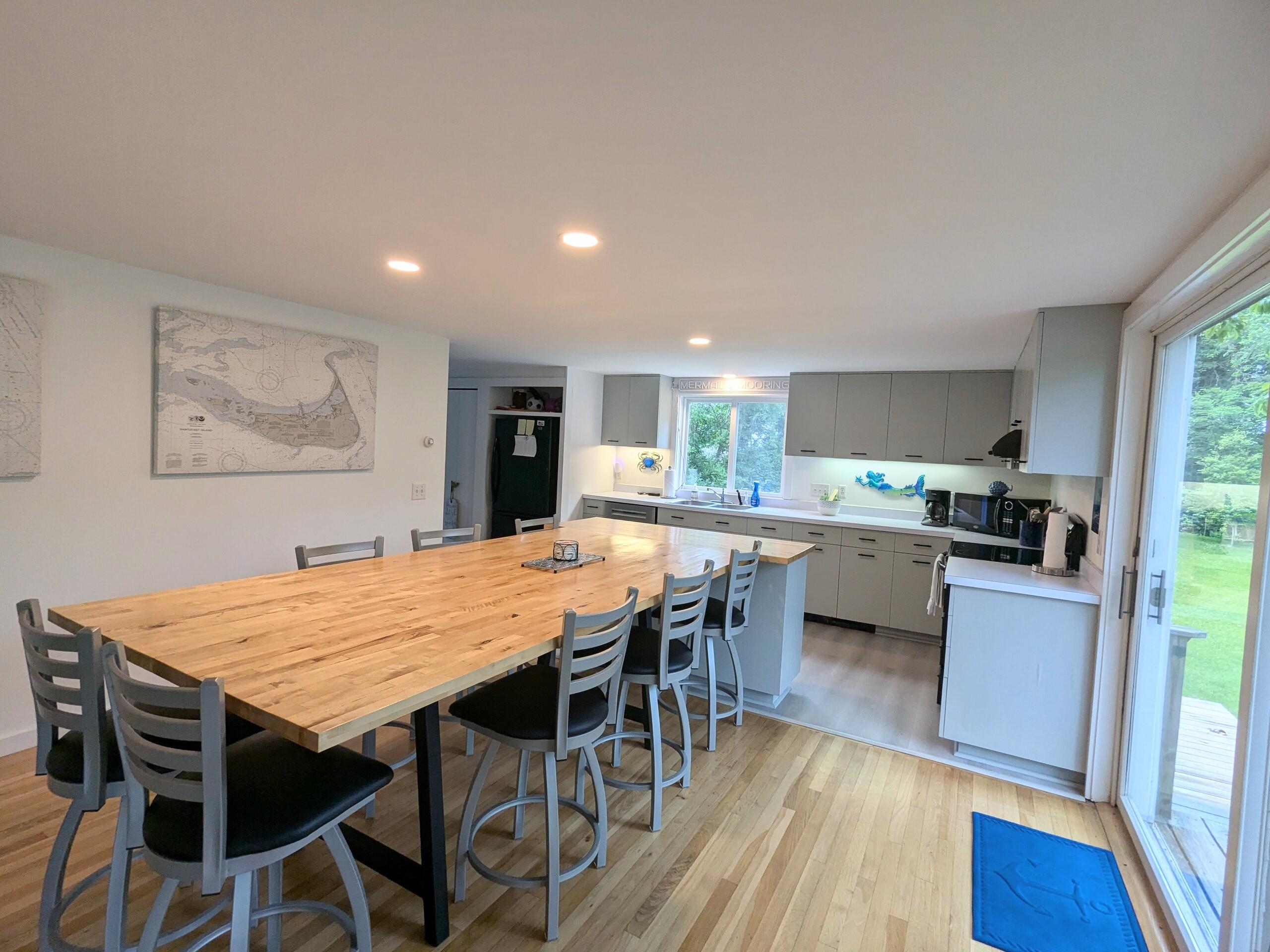 29 Pilgrim Road Dennis, MA 02638 - Photo 17 of 54 a kitchen with stainless steel appliances kitchen island granite countertop a table chairs sink and cabinets