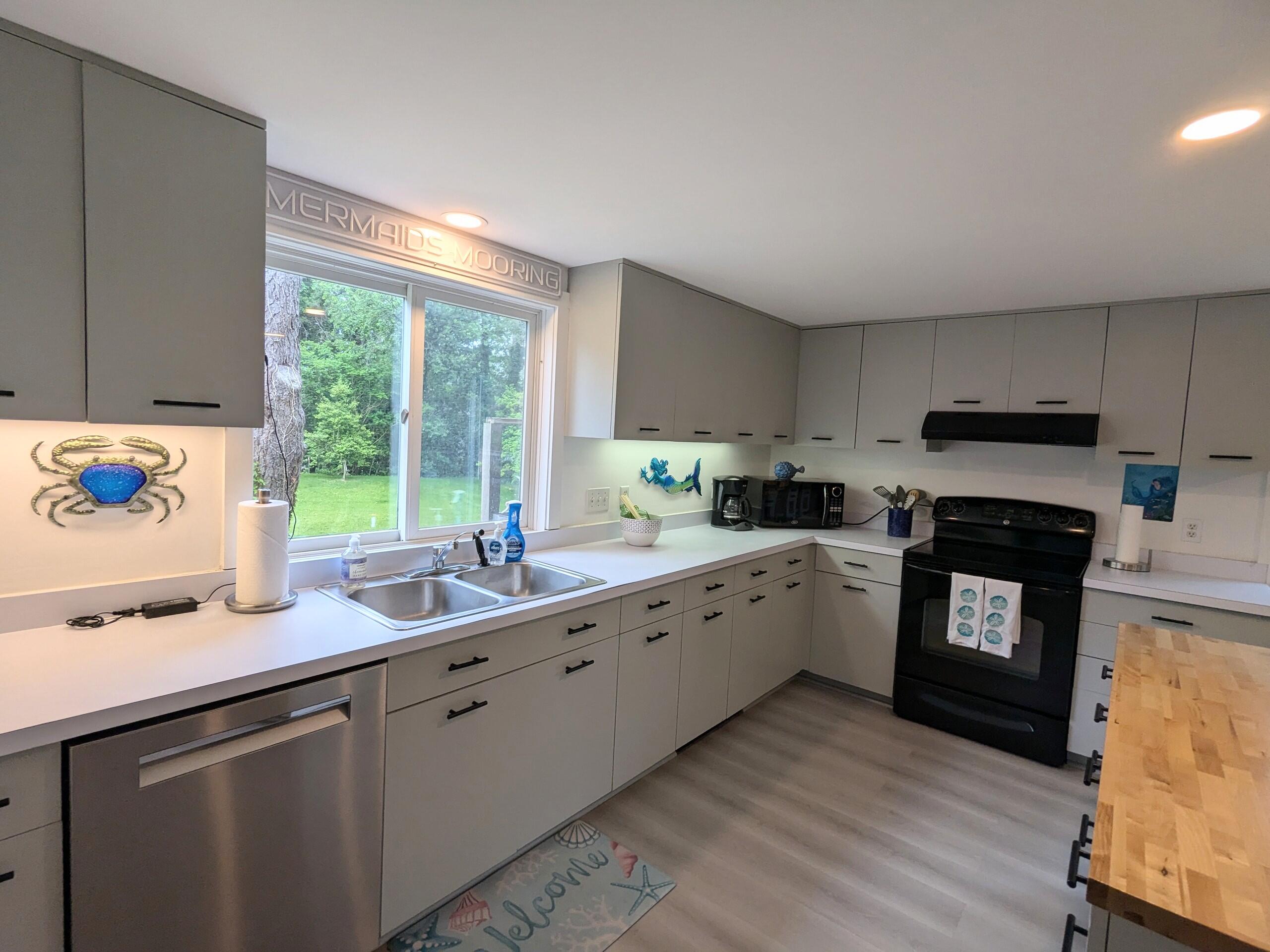 29 Pilgrim Road Dennis, MA 02638 - Photo 22 of 54 a kitchen with granite countertop cabinets stainless steel appliances a sink and a large window