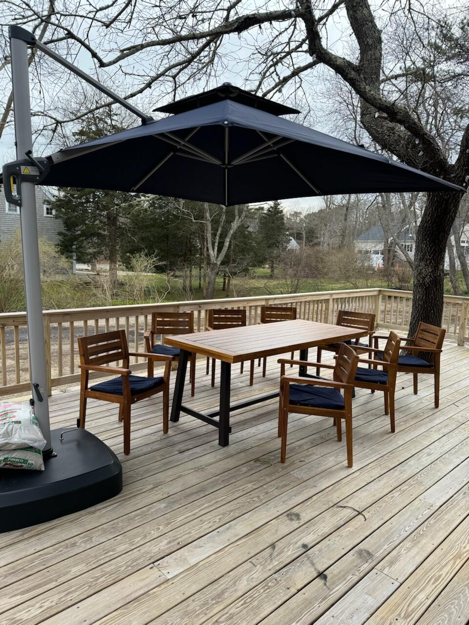 29 Pilgrim Road Dennis, MA 02638 - Photo 35 of 54 a view of a roof deck with table and chairs under an umbrella
