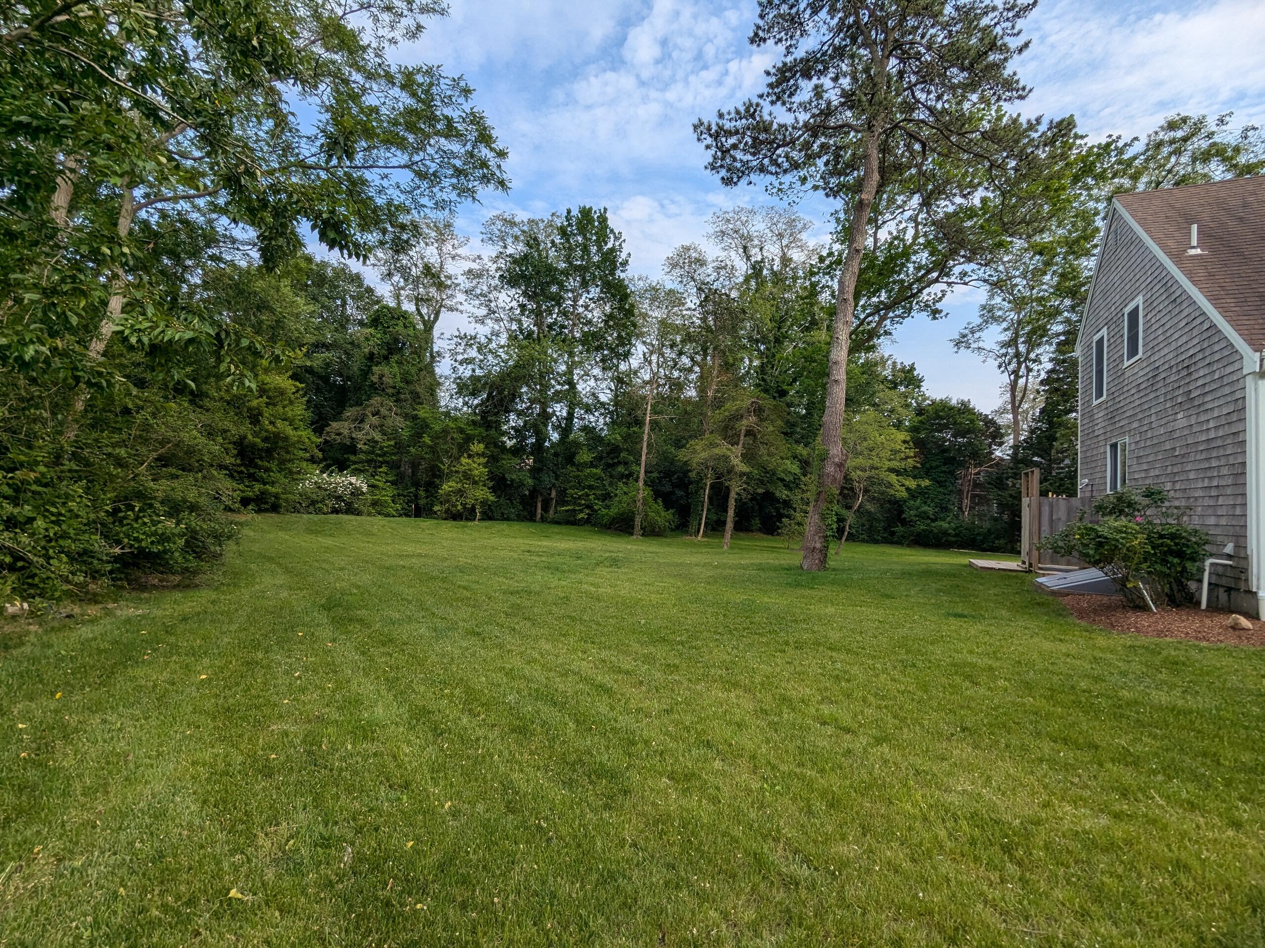 29 Pilgrim Road Dennis, MA 02638 - Photo 46 of 54 a view of a grassy field with trees